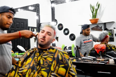 Barber working on client haircut